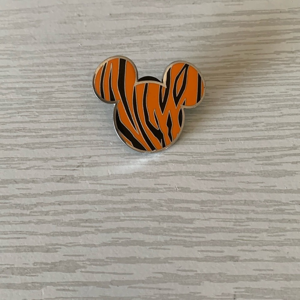 Disney Mickey Mouse trading pin with a tiger stripe design.